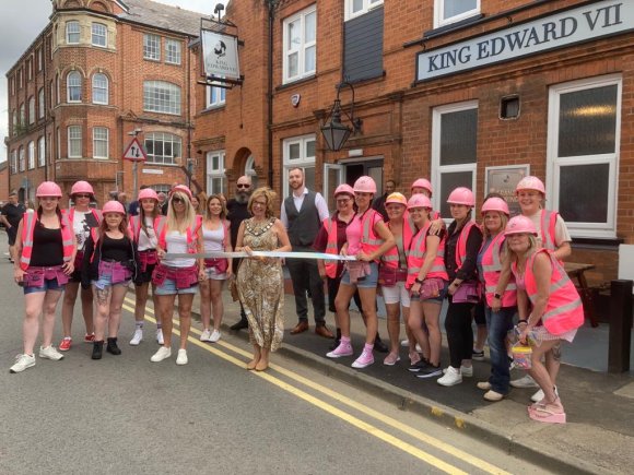 Town Mayor, Cllr Mrs Melanie Coleman, alongside charity fundraisers
'The Pink Builders' helped cut the ribbon for the official opening
of The King Edward pub in Rushden.

~~~